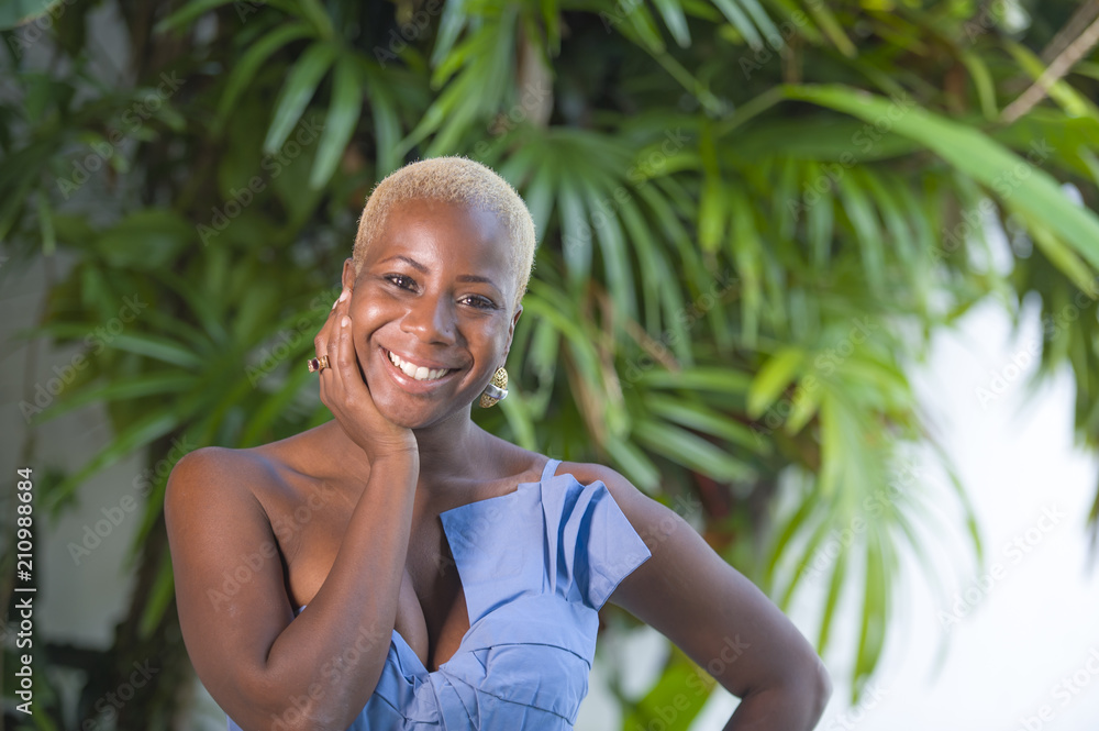 lifestyle portrait of young attractive and joyful black african american woman smiling happy posing cheerful at home terrace with green plants background lifestyle portrait of young attractive and joyful black african american woman smiling happy posing cheerful at home terrace with green plants background