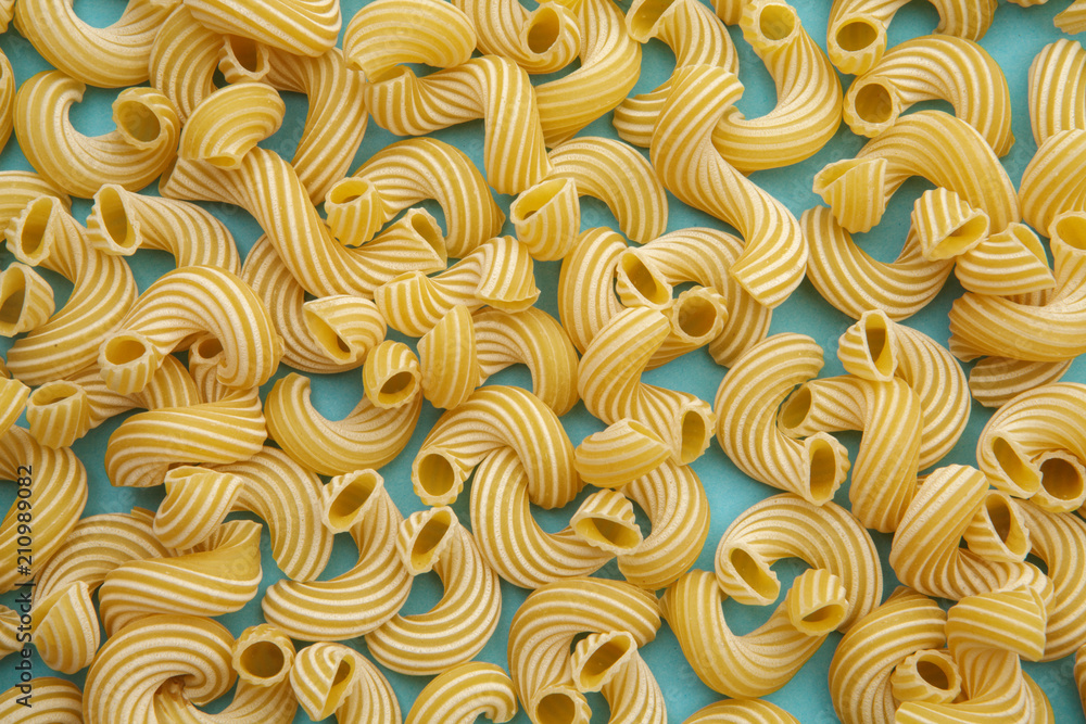 background of pasta in the form of tubes spun in a spiral background of pasta in the form of tubes spun in a spiral