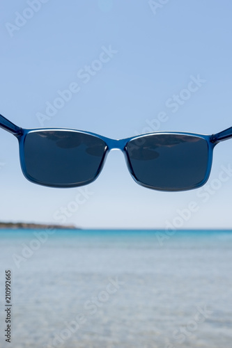 Blue sunglasses with polarized lenses that protect your eyes from bright sea light