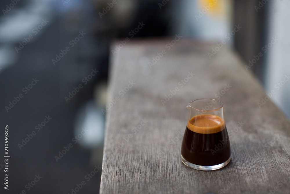 Espresso shot on the wooden table. Summer outdoor cafe. Copy-space for your text. Espresso shot on the wooden table. Summer outdoor cafe. Copy-space for your text.