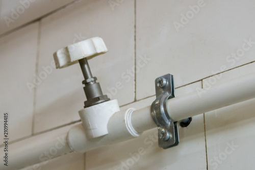 White plastic water pipes of plumbing system with valve