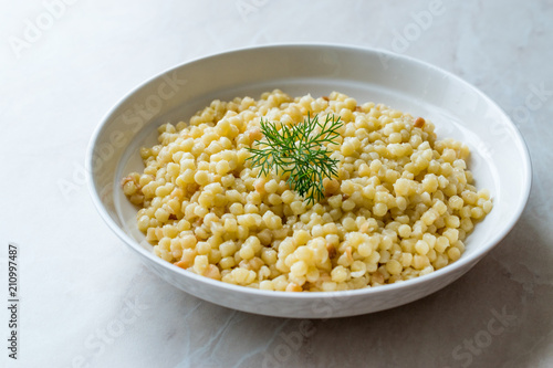 Cooked Couscous with Dill served in White Plate / Turkish Kuskus