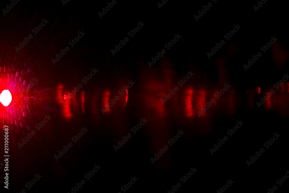 Camera lens flare by laser light create effect depending of iris shapes and interference effect and moire on digital sensor on dark black background