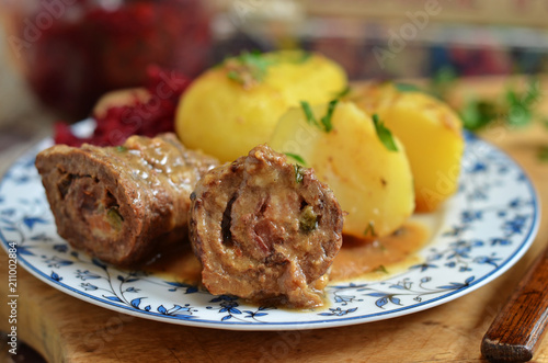 Photos Beef roulades wrapped on a plate with potatoes