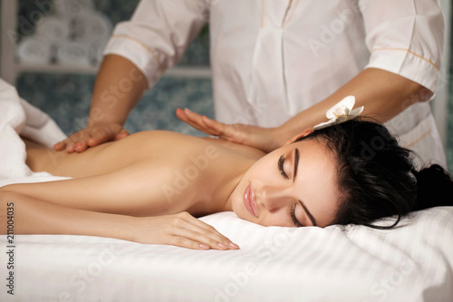 Relaxed woman receiving massage