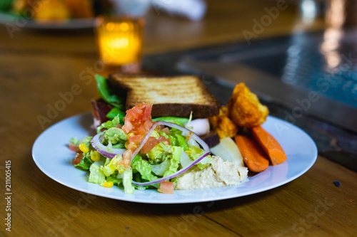 A healthy plate of food for lunch with salad, bread and veggies