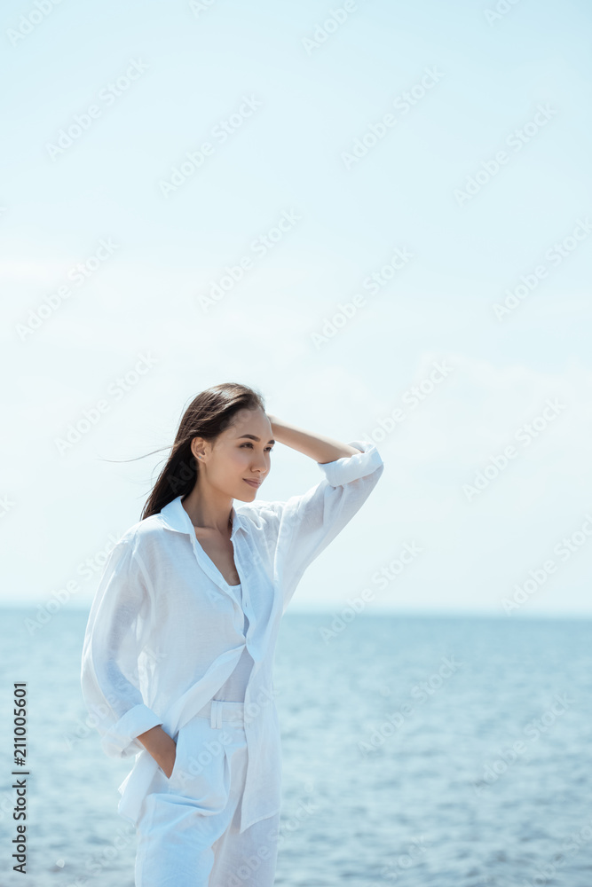 attractive young asian female traveler standing near sea attractive young asian female traveler standing near sea