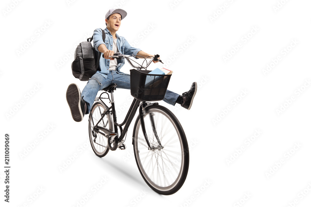 Joyful teenage boy with a backpack riding a bicycle Joyful teenage boy with a backpack riding a bicycle