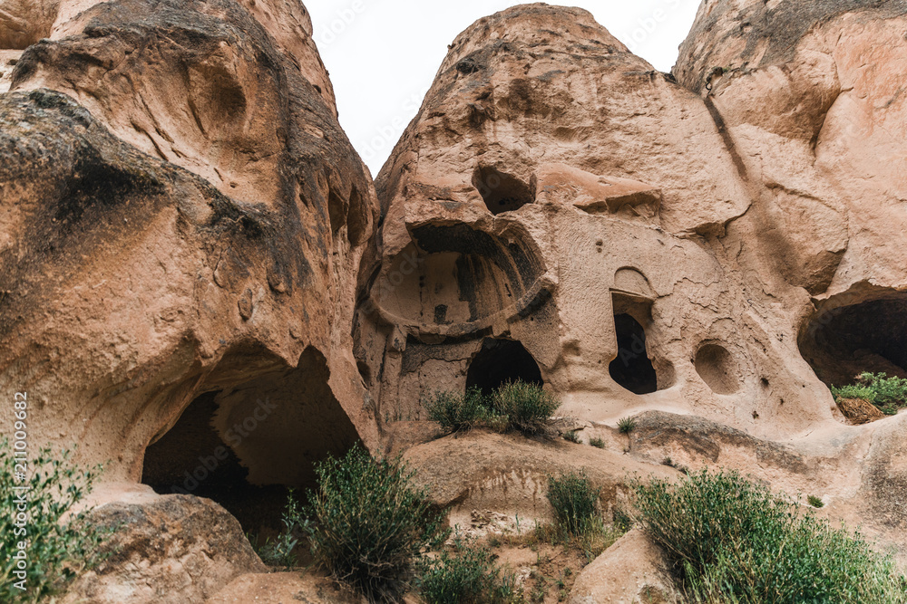 low angle view of beautiful caves in sandstone at famous cappadocia, turkey low angle view of beautiful caves in sandstone at famous cappadocia, turkey
