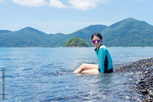 Beautiful woman sitting on the beach. Lipe island Thailand. © narongchaihlaw