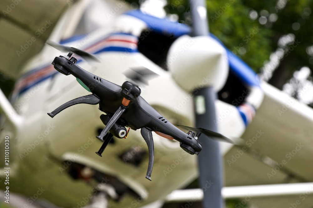The drone in flight with signal lights produces video and photography of the neighborhood The drone in flight with signal lights produces video and photography of the neighborhood