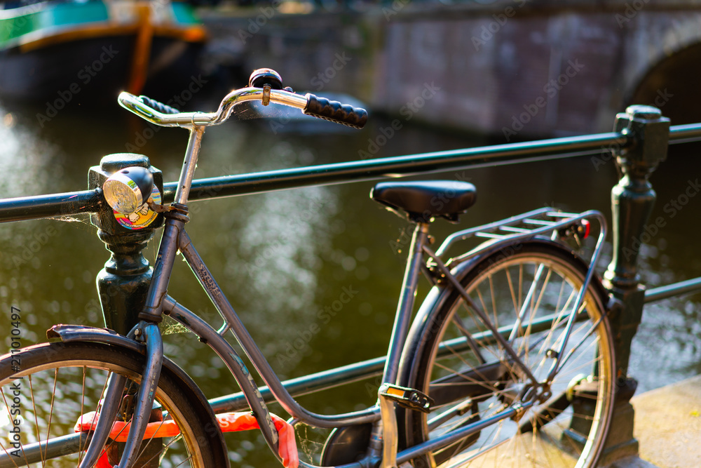 Bike against a rail over a canal in golden hour Bike against a rail over a canal in golden hour