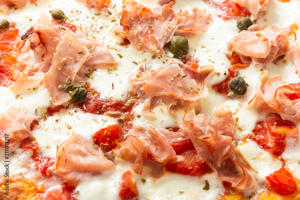 Pizza with prosciutto cotto ham, mozzarella, tomato sauce, capers and oregano Pizza with prosciutto cotto ham, mozzarella, tomato sauce, capers and oregano