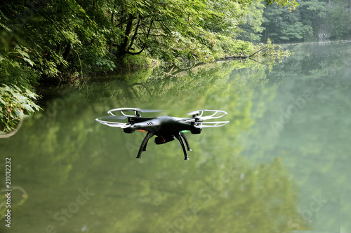 The drone in flight with signal lights produces video and photography of the neighborhood