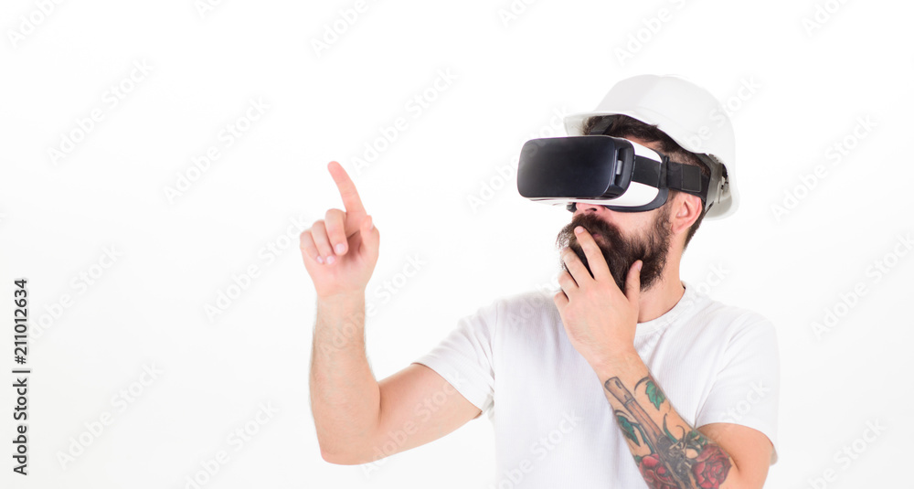 Thoughtful architect making new project using digital touch screen. Builder with beard in helmet isolated on white background. Bearded man in VR glasses having 3D experience, virtual reality concept Thoughtful architect making new project using digital touch screen. Builder with beard in helmet isolated on white background. Bearded man in VR glasses having 3D experience, virtual reality concept