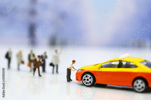 Miniature people   businessman waiting for a taxi in front of the airport business meeting concept.