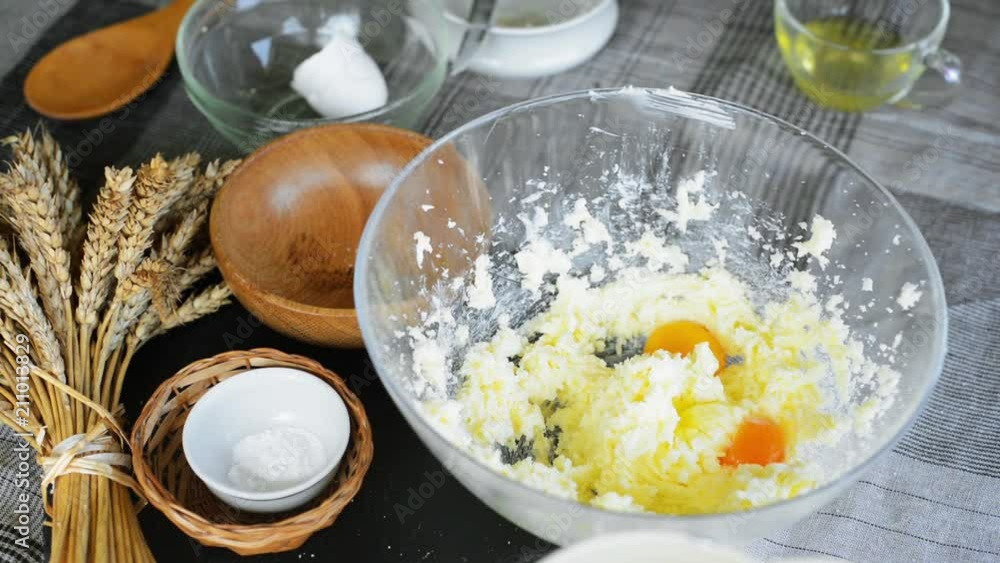 Woman add ingredients for tartlet dough Woman add ingredients for tartlet dough