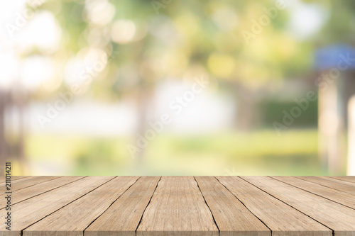 Wood table top on blurred background at garden,for montage your products