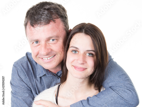 father and teen daughter hug posing portrait for camera