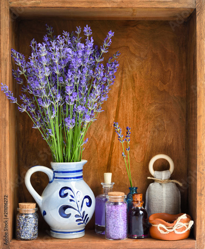 Natural cosmetics with flowers of lavender on wooden background