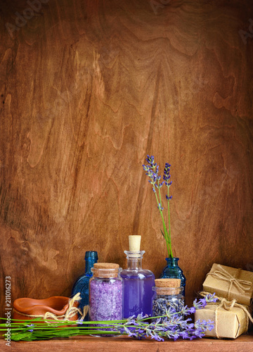 Natural cosmetics with flowers of lavender on wooden background