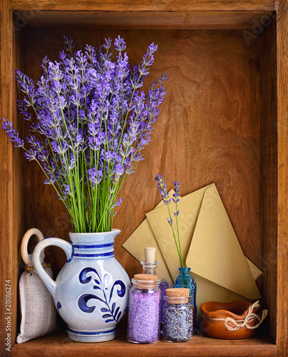 Natural cosmetics with flowers of lavender on wooden background