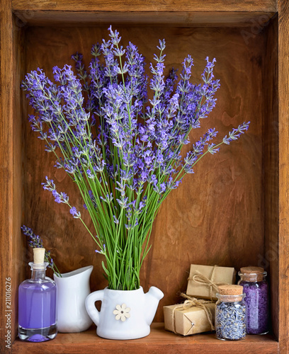 Natural cosmetics with flowers of lavender on wooden background