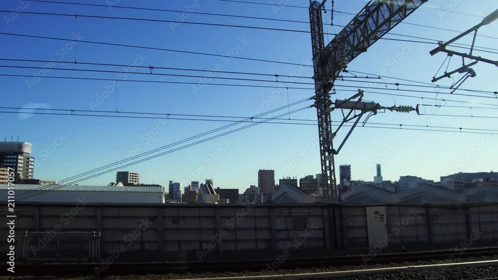 transportation and urban concept - view to city from moving train or railway in japan transportation and urban concept - view to city from moving train or railway in japan