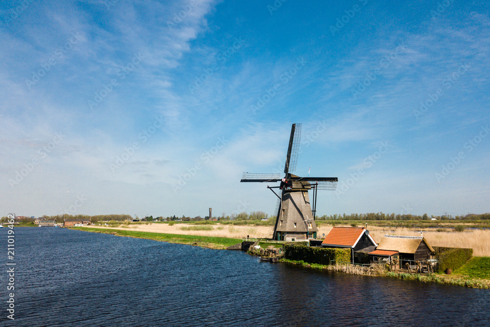 Windmills and water canal in Kinderdijk in a beautiful spring da