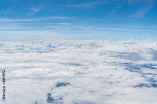 Fototapeta Naklejka Na Ścianę i Meble -  The blue sky with clouds, background.
view from Airplane.
