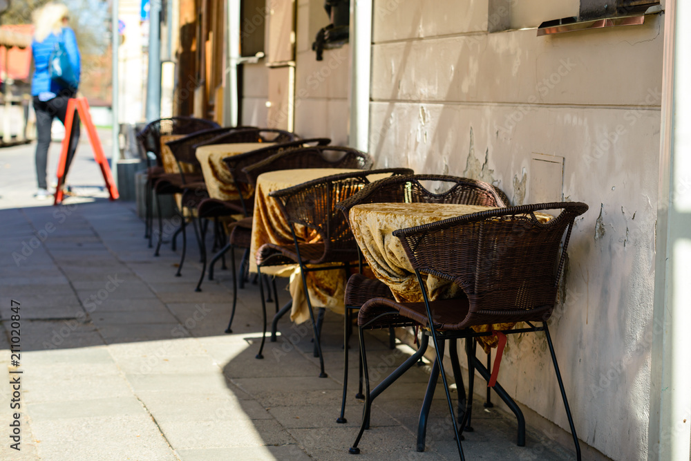 Naklejka premium Street cafe or restaurant in the European city. Brown chairs and