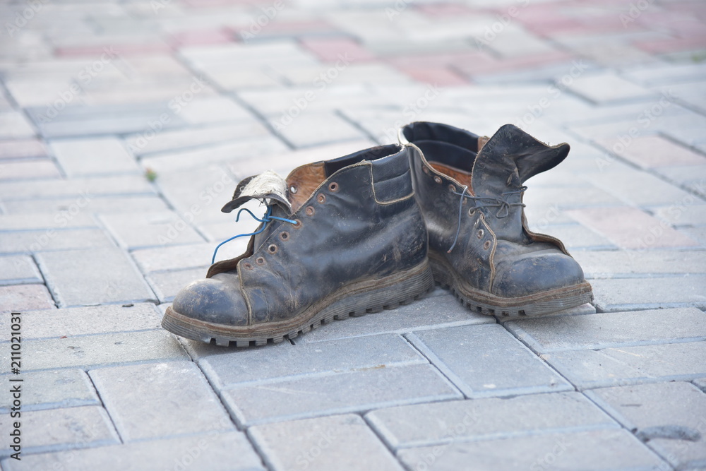 Old bad worn out dirty ragged boots shoes Old bad worn out dirty ragged boots shoes