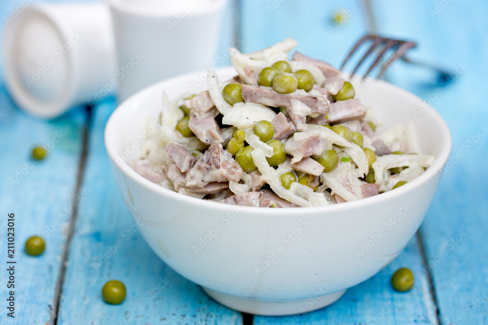 Boiled beef tongue, marinated onion and peas salad with mayonnaise dressing, russian cuisine Boiled beef tongue, marinated onion and peas salad with mayonnaise dressing, russian cuisine