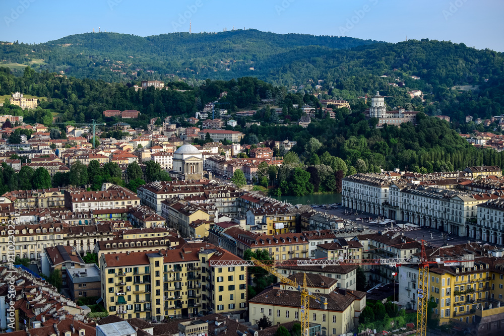 View of the whole of a city and its monuments as well as a backdrop mountains, review the San Marco square from the heights. Photograph taken in Turin, Italy.