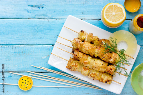 Grilled chicken and pineapple skewers with lemon and turmeric in hawaiian style