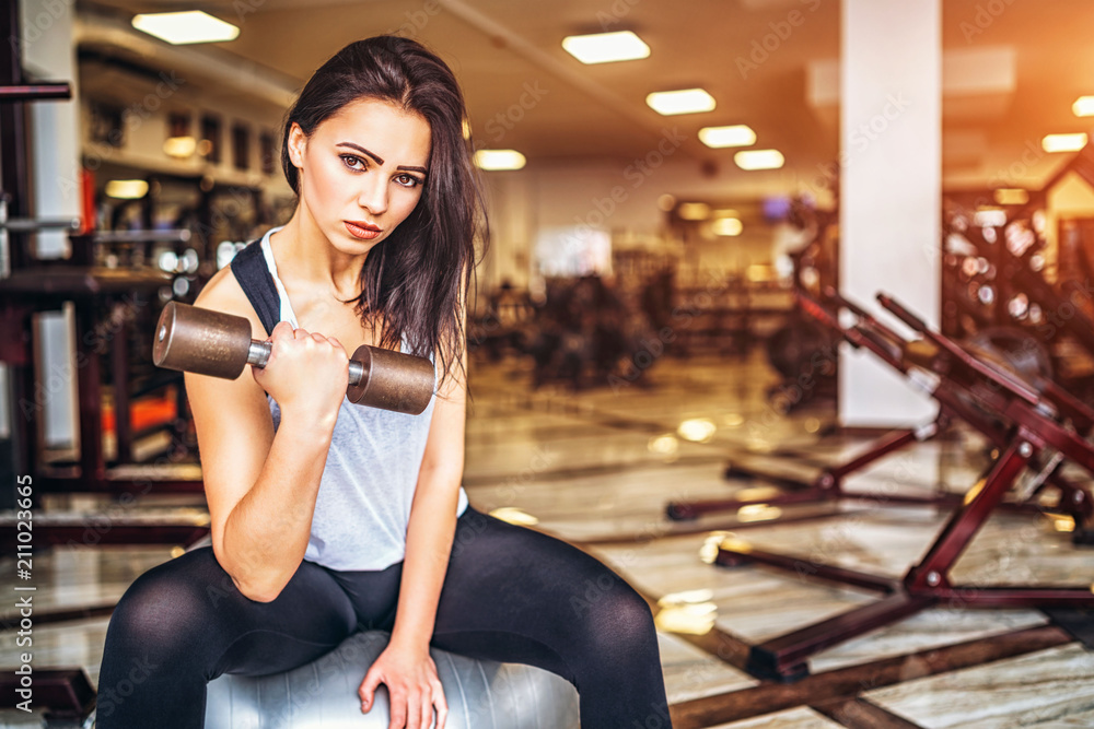 Fototapeta premium Cute sporty girl workout in the gym