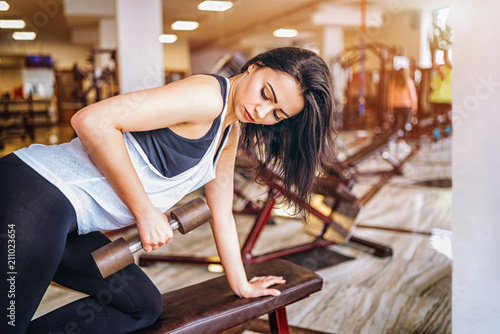 Cute sporty girl workout in the gym