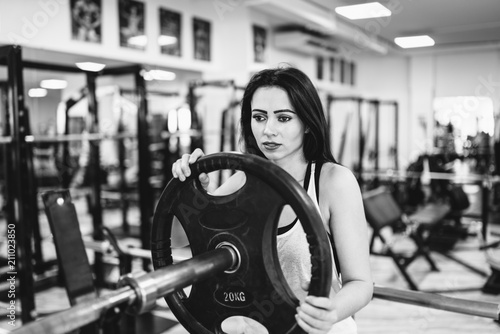 Cute sporty girl workout in the gym