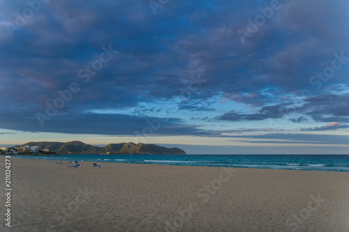 Fototapeta Naklejka Na Ścianę i Meble -  Mallorca, Dawning sky at white sand beach with sunbeds