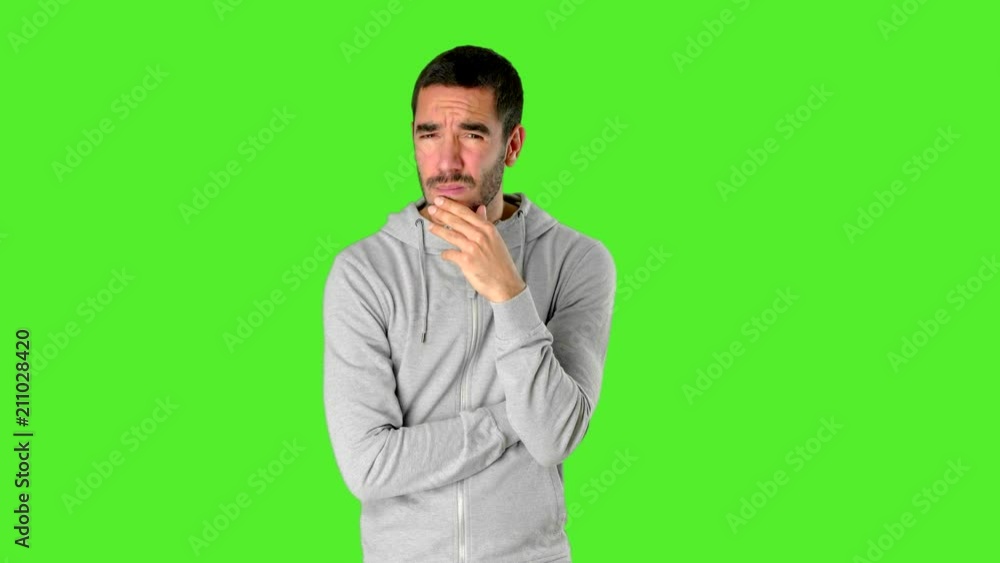 Doubtful young man on chroma screen Doubtful young man on chroma screen