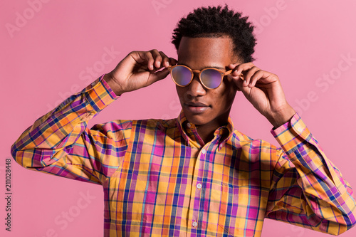 Stylish hipster man in sunglasses and shirt photo