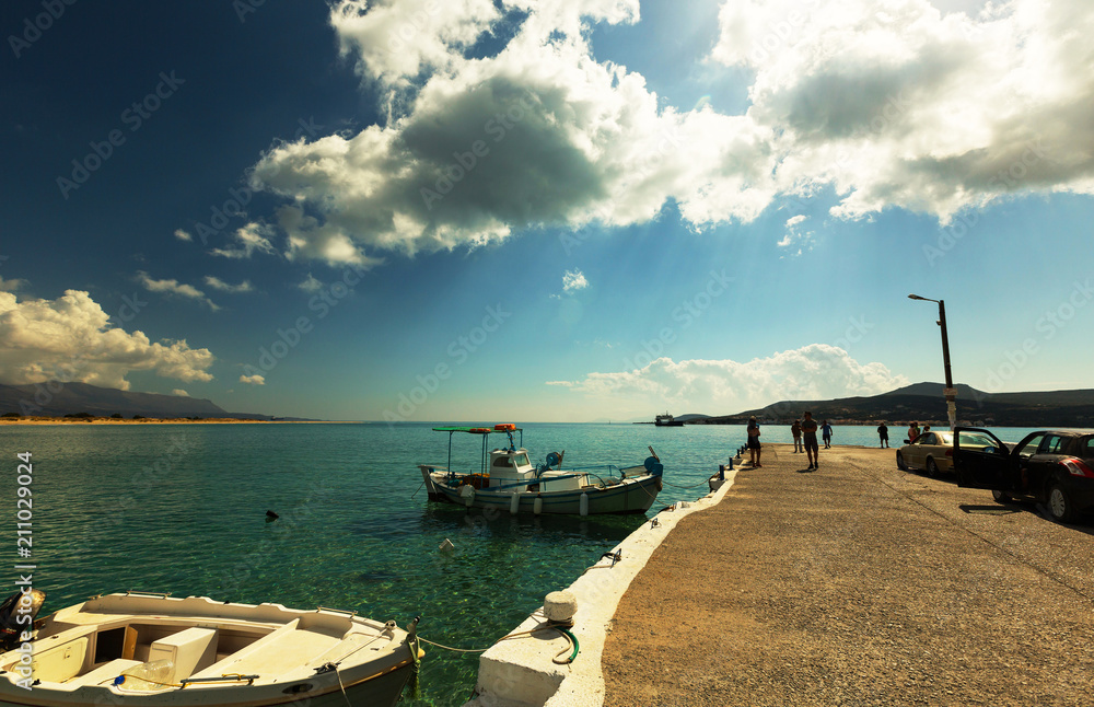Obraz premium Tourists on the berth of the ferry to the island of Elafonisos, Lakonia, Greece