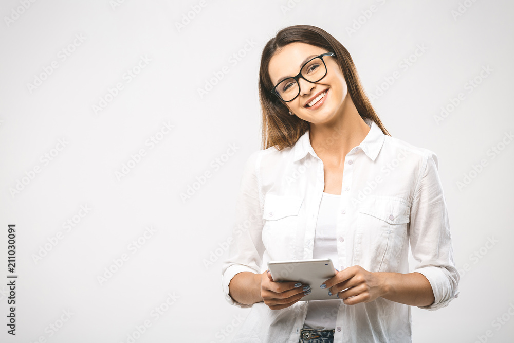 Portrait with copy space empty place of pretty charming confident trendy woman in classic shirt having tablet in hands isolated on white background Portrait with copy space empty place of pretty charming confident trendy woman in classic shirt having tablet in hands isolated on white background