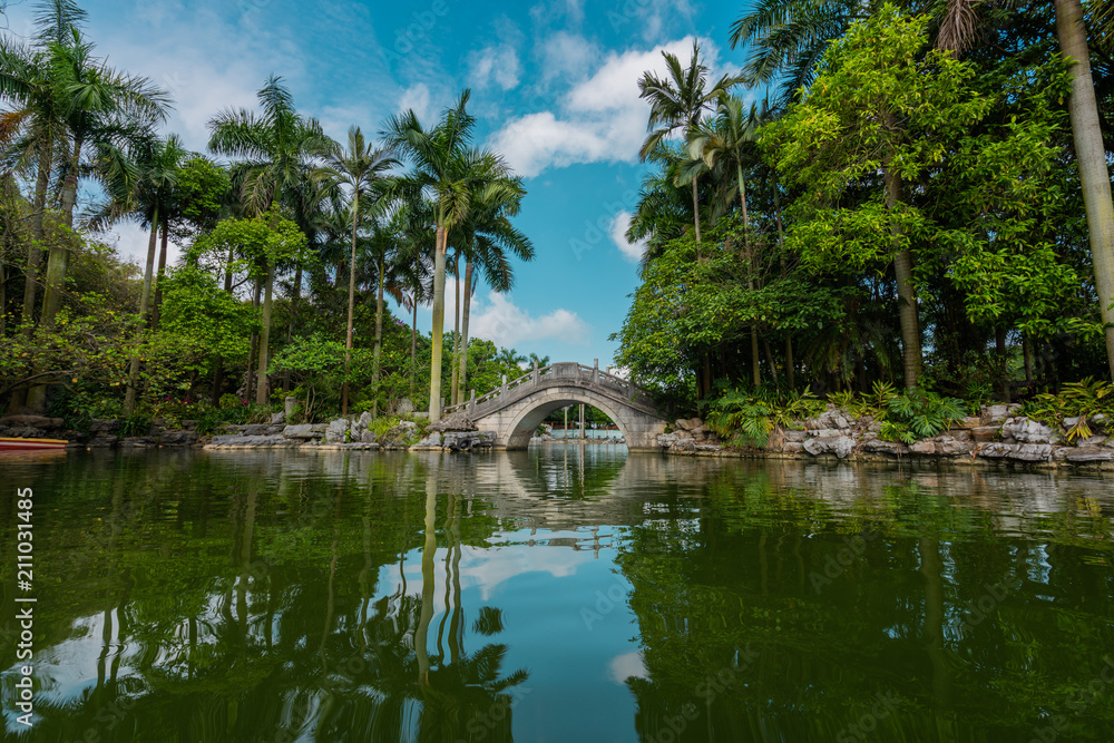 Stone oriental bridge on tropical park Stone oriental bridge on tropical park