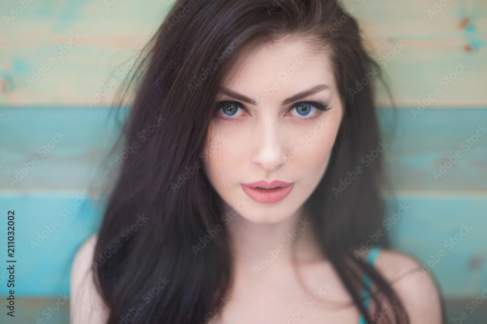 portrait of pretty caucasian girl with blue eyes on colorful wooden background portrait of pretty caucasian girl with blue eyes on colorful wooden background