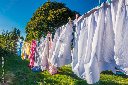 Clothes hanging to dry on a washing line in a back garden