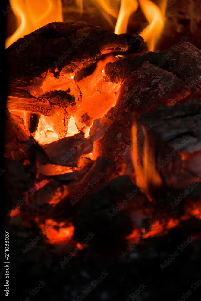 Crest of flame on burning wood in fireplace. Burning firewood in a Russian stove. Crest of flame on burning wood in fireplace. Burning firewood in a Russian stove.