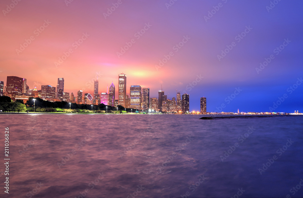 Chicago, Illinois, USA - June 22, 2018 - The Chicago skyline at night after a storm across Lake Michigan. Chicago, Illinois, USA - June 22, 2018 - The Chicago skyline at night after a storm across Lake Michigan.