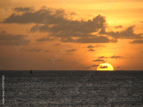 Sun setting into the ocean.