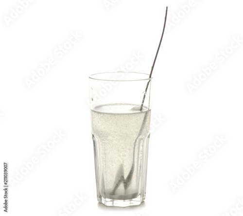 A glass of salt of soda for rinsing teeth on a white background isolation